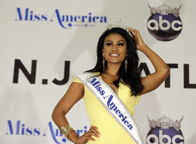 Miss America Nina Davuluri poses for photographers following her crowning in Atlantic City, N.J. For some who observe the progress of people of color in the U.S., Davaluri's victory in the Miss America pageant shows that Indian-Americans can become icons even in parts of mainstream American culture that once seemed closed. (AP Photo/Mel Evans).
