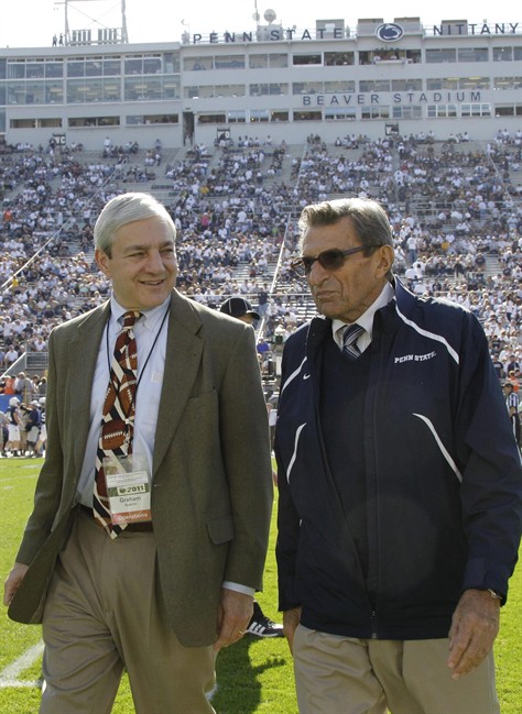 FILE - In this Oct. 8, 2011 file photo Penn State president Graham Spanier, left, and head football coach Joe Paterno talk before an NCAA college football game against Iowa in State College, Pa.