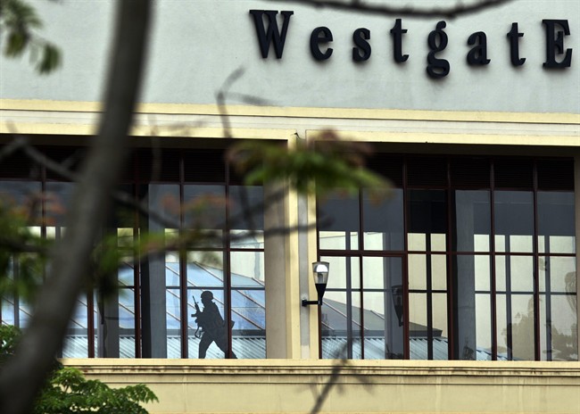 In this Tuesday, Sept. 24, 2013, file photo, a Kenyan soldier runs through a corridor on an upper floor, shortly before an explosion was heard, at the Westgate Mall in Nairobi, Kenya. 
