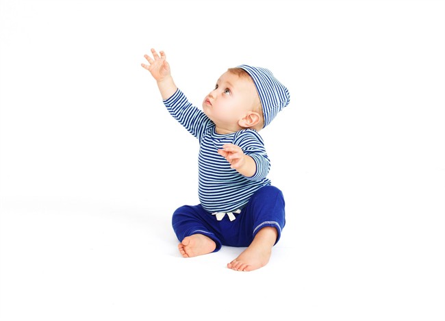 This product image released by J. Crew shows a Nature Baby blue and white striped cotton one-piece with matching knotted beanie and a blue cotton pant from J. Crew's new baby collection, launching Wednesday, Sept. 18, 2013. 