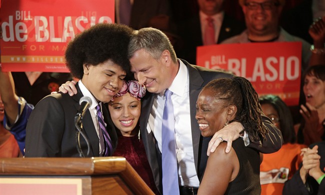 New York City Democratic Mayoral hopeful Bill De Blasio embraces his son Dante, left, daughter Chiara, second from left, and wife Chirlane, right, after addressing supporters at his election headquarters after polls closed in the city's primary election Wednesday, Sept. 11, 2013, in New York. 