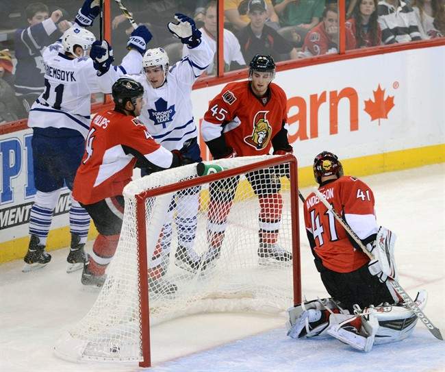 Toronto Maple Leafs' Mason Raymond, back right, celebrates a goal with teammate James Van Riemsdyk, back left, against Ottawa Senators goalie Craig Anderson during a preseason NHL hockey game in Ottawa, Ontario on Thursday, Sept. 19, 2013.