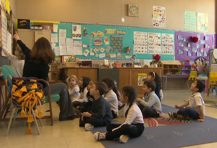 School children sit in a classroom.