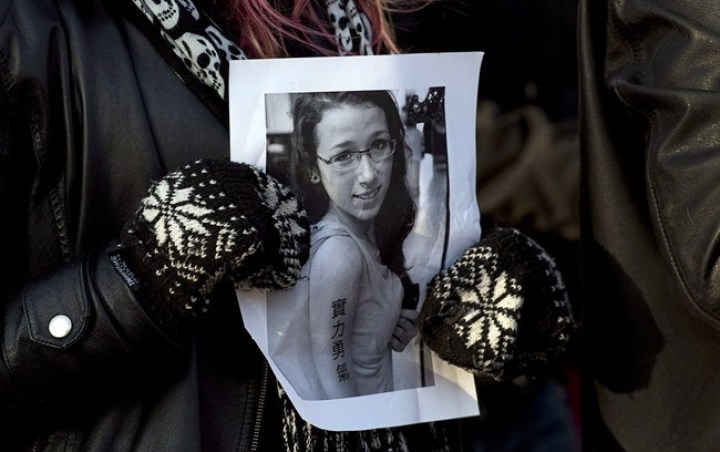 A woman holds a photo of Rehtaeh Parsons in Halifax on April 11, 2013.