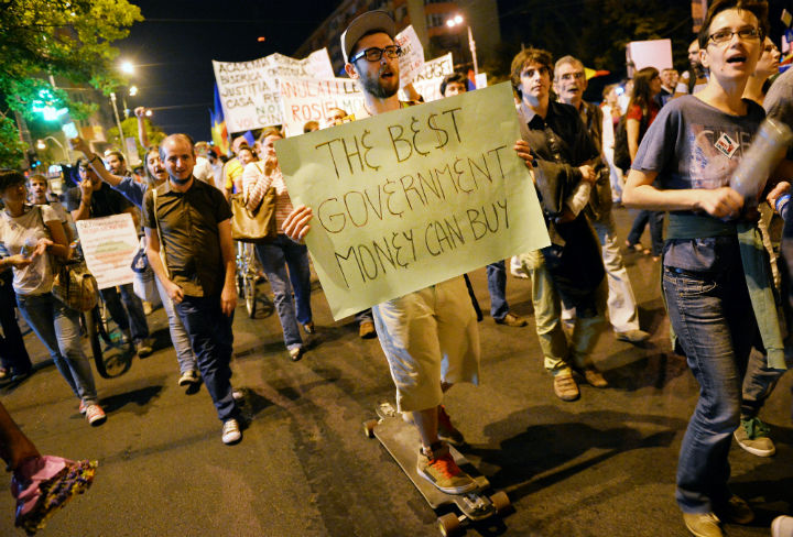 Protesters march and hold banners during the eight day of demonstrations in Bucharest against the Rosia Montana Gold Corporation (RMGC), a Canadian gold mine project using cyanide, on September 8, 2013. (Photo: Daniel Mihailescu/AFP/Getty Images)