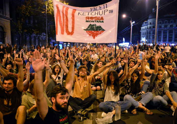 People demonstrate as they occupy a central boulevard in Bucharest against Rosia Montana Gold Corporation (RMGC), a Canadian gold mine project using cyanide, in Bucharest September 2, 2013. About a thousand people marched for the second consecutive day in Bucharest against a Canadian goldmine project planning to use large amounts of cyanide in the village of Transylvania. ‘Romania is not for sale’ or ‘United, we will save Rosia Montana,’ chanted the demonstrators, referring to the village where the Canadian company Gabriel Resources says it discovered the largest gold deposit in Europe.(Photo: Daniel Mihailescu/AFP/Getty Images)