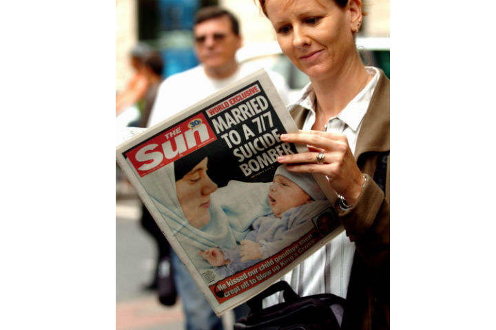 A woman holds a copy of the British tabloid newspaper The Sun, in London, Friday, Sept. 23, 2005 which carries on its front page their story of Samantha Lewthwaite, wife of suspected London suicide bomber Germaine Linsday. (Photo: Andrew Stuart/AP Photo)