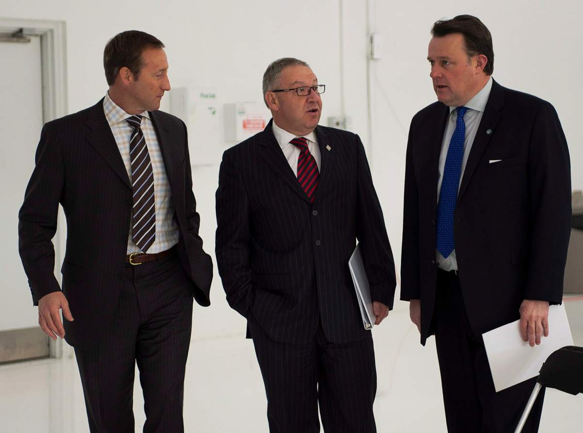 Defence Minister Peter MacKay, Premier Darrell Dexter and Mayor Mike Savage, left to right, attend a ceremony to mark the official opening of a newly extended runway at Halifax Stanfield International Airport in Halifax on Jan. 21, 2013. 
