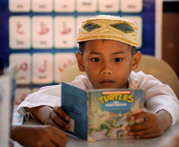 Muslim student Al-Khaizar Aranan reads a book.