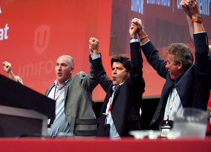 Jerry Dias, centre, celebrates after being declared the first president of the new Unifor union at the Unifor founding convention in Toronto, Saturday, August 31, 2013. THE CANADIAN PRESS/Galit Rodan.
