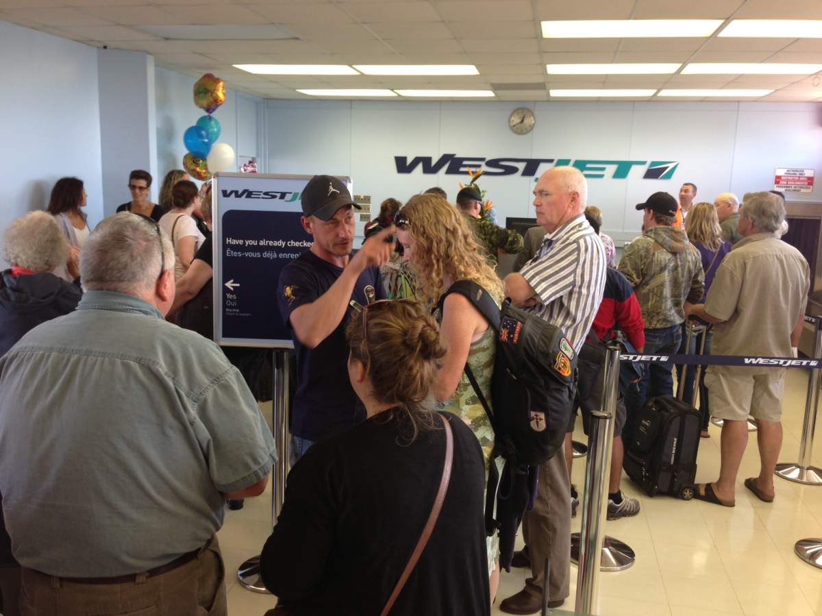 Brandonites wait to check in at the WestJet desk in the Brandon Airport Tuesday afternoon.