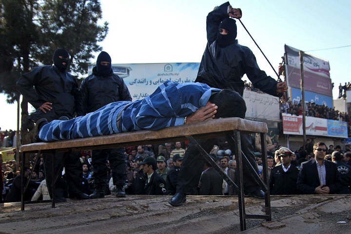 FILE -- An Iranian officer lashes a man, convicted of rape, at the northeastern city of Sabzevar, Iran, Wednesday, Jan. 16, 2013. Rape, like murder and treason, can be punished by the death sentence in Iran, but sometimes judges imposed a sentence of lashes before execution or imprisonment.