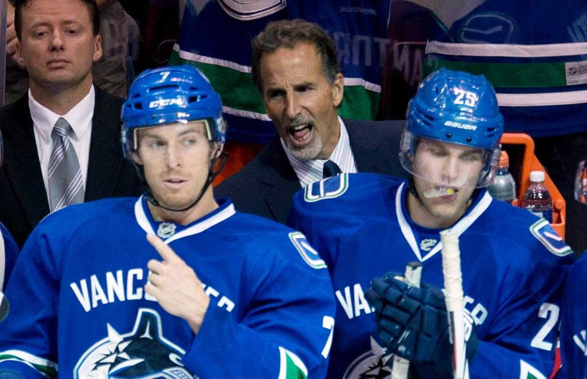 Vancouver Canucks head coach John Tortorella, centre, is seen during a game against the New York Rangers in Vancouver on Thursday, Sept 26, 2013. THE CANADIAN PRESS/Jonathan Hayward.