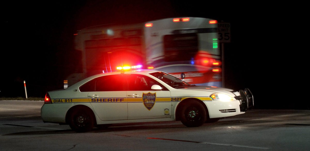 Police block the road to the Jacksonville International Airport terminal as a shuttle used to move people out of the airport drives by Tuesday, Oct. 1, 2013, in Jacksonville, Fla.