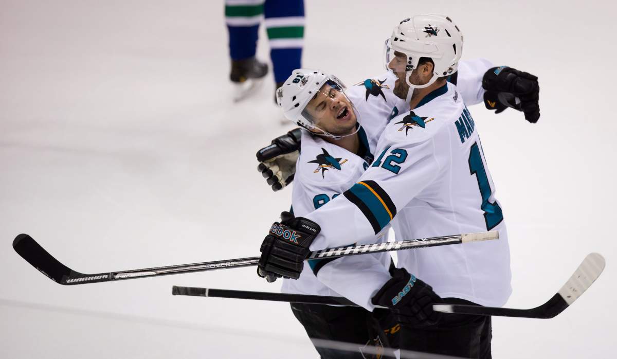 San Jose Sharks' Tyler Kennedy, left, and Patrick Marleau celebrate Marleau's goal against the Vancouver Canucks during the second period. THE CANADIAN PRESS/Darryl Dyck.