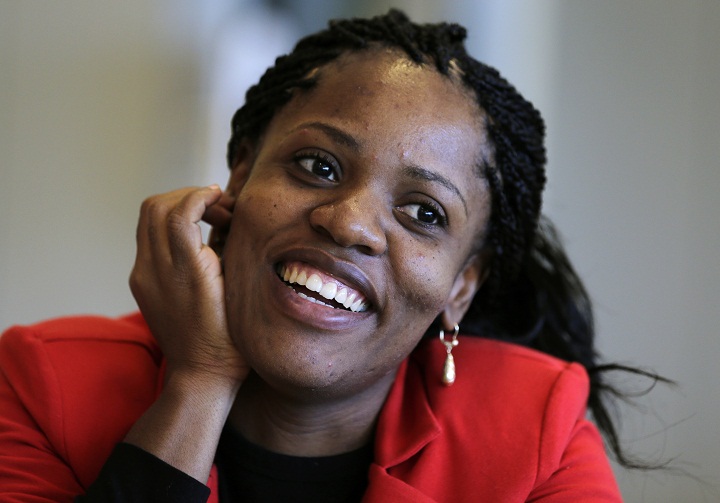 In this Friday, Sept. 27, 2013 photo, Mery Daniel smiles in the cafeteria at Spaulding Rehabilitation Hospital in Boston. Daniel has made strides in regaining mobility and independence since losing most of her left leg in the Boston Marathon bombings on April 15.