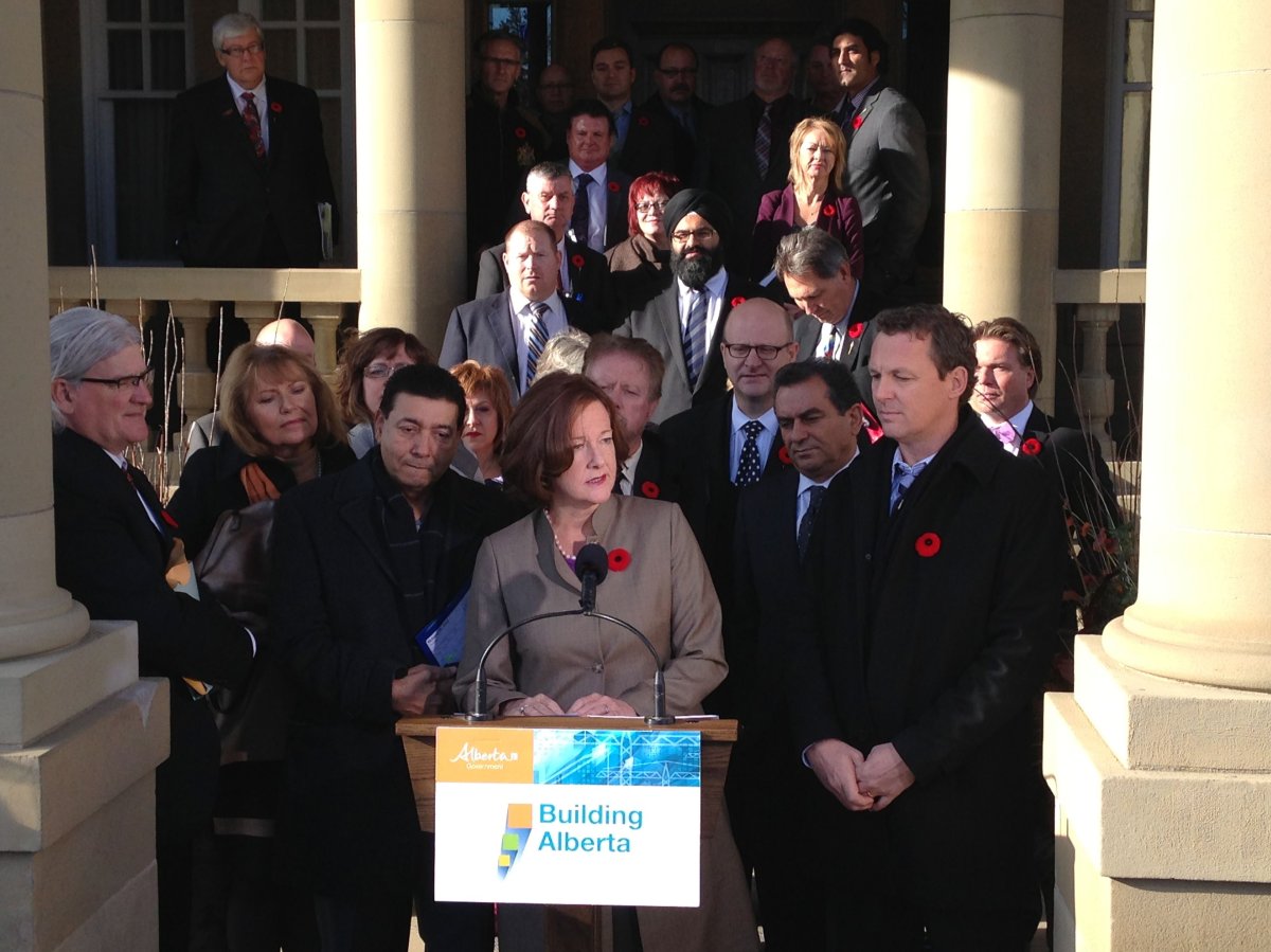 Premier Alison Redford stands with Municipal Affairs Minister Doug Griffiths, on October 31, 2013.