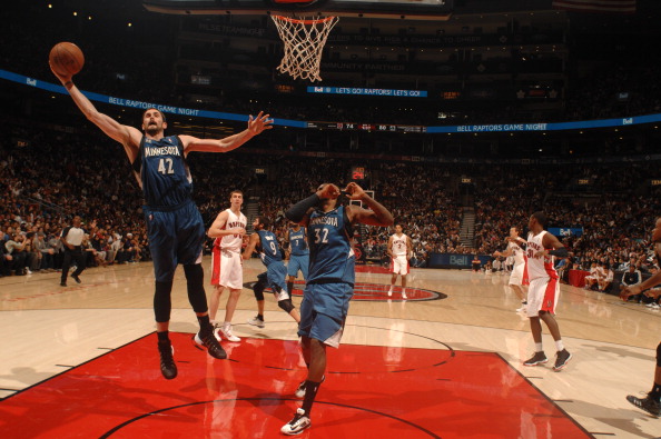 Kevin Love #42 of the Minnesota Timberwolves rebounds against the Toronto Raptors during the game on October 9, 2013 at the Air Canada Centre in Toronto, Ontario, Canada. 