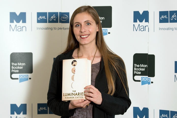 Eleanor Catton poses with her book 'The Luminaries' in October 2013.