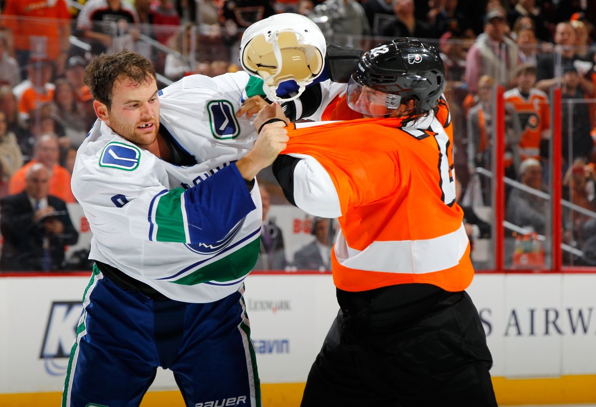 Zack Kassian trades first period punches with Luke Schenn of the Philadelphia Flyers. (Photo by Jim McIsaac/Getty Images).