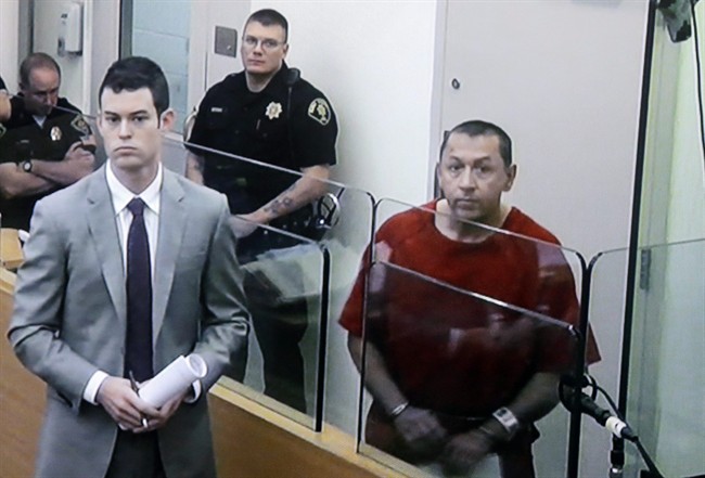 In this image photographed from a video monitor, Michael Sean Stanley, right, appears in court with defense attorney Nick Gross, Wednesday, Oct. 23, 2013, in Seattle. 
