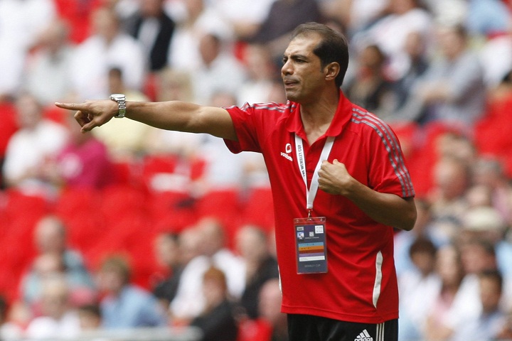 Al Ahly's manager Hossam El-Badry reacts as he watches his team play against Barcelona during their Wembley Cup soccer match at Wembley Stadium, London, Sunday, July 26, 2009. 
