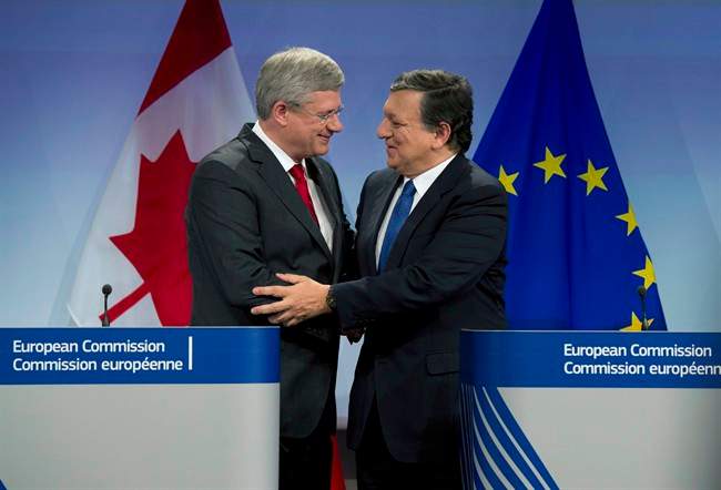 Canadian Prime Minister Stephen Harper and European Commission President Jose Manuel Barroso shake hands following a joint media availability Friday, October 18, 2013 at the European Commission in Brussels, Belgium. THE CANADIAN PRESS/Adrian Wyld.