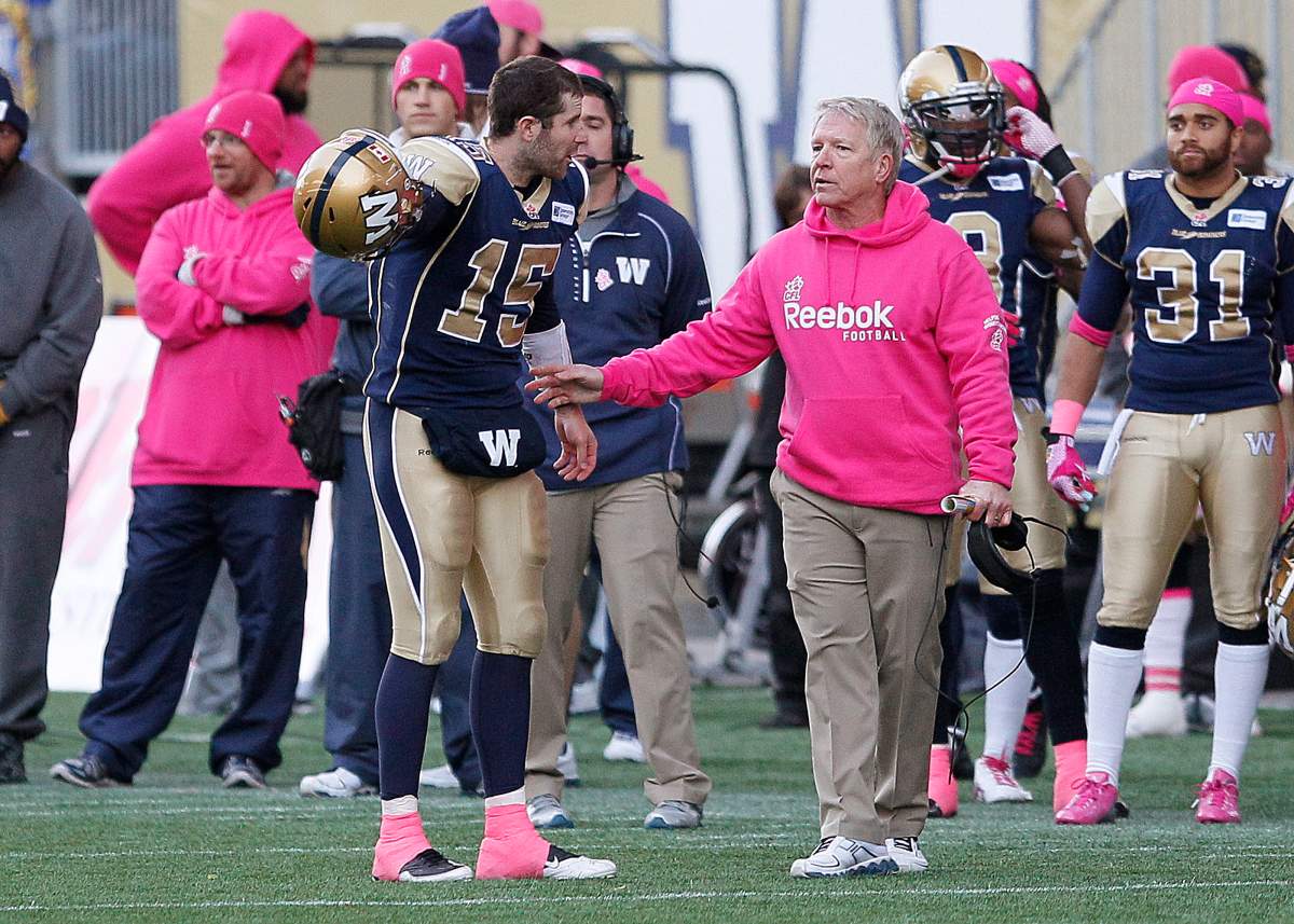 Winnipeg Blue Bombers quarterback Max Hall (15) with head coach Tim Burke is upset at getting a time-count penalty late in the second half of CFL action in Winnipeg Saturday.