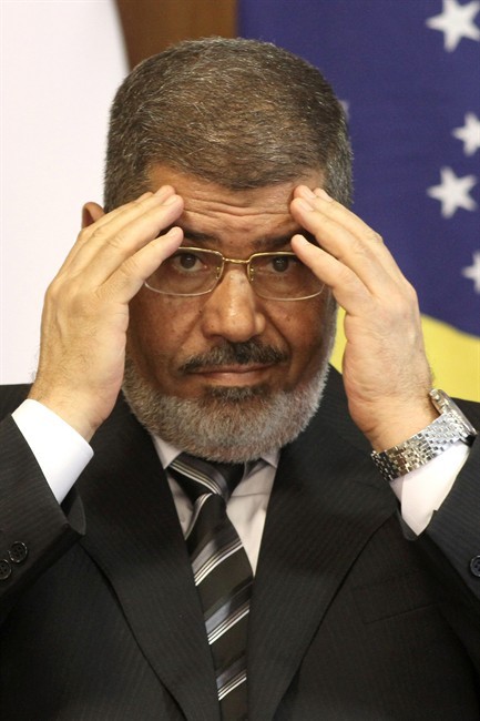 FILE - In this file photo taken Wednesday, May 8, 2013, Egyptian President Mohammed Morsi attends a bi-lateral signing ceremony with Brazil's president at the Planalto presidential palace in Brasilia, Brazil. 