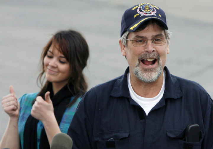 In this April 17, 2009 file photo, Capt. Richard Phillips smiles after arriving on a plane in South Burlington, Vt.. At rear is his daughter, Mariah. (Photo by Toby Talbot/AP Photo, File)