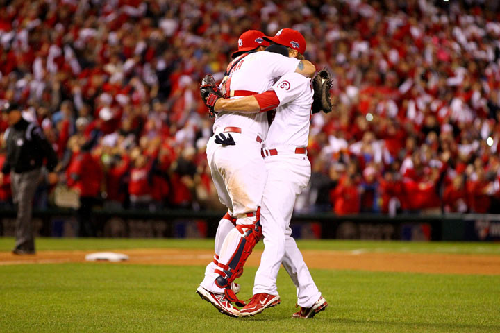 Trevor Rosenthal #26 and catcher Yadier Molina #4 of the St. Louis Cardinals celebrate after the Cardinals defeat the Los Angeles Dodgers 9-0 in Game Six of the National League Championship Series at Busch Stadium on October 18, 2013 in St Louis, Missouri. (Photo by Dilip Vishwanat/Getty Images).