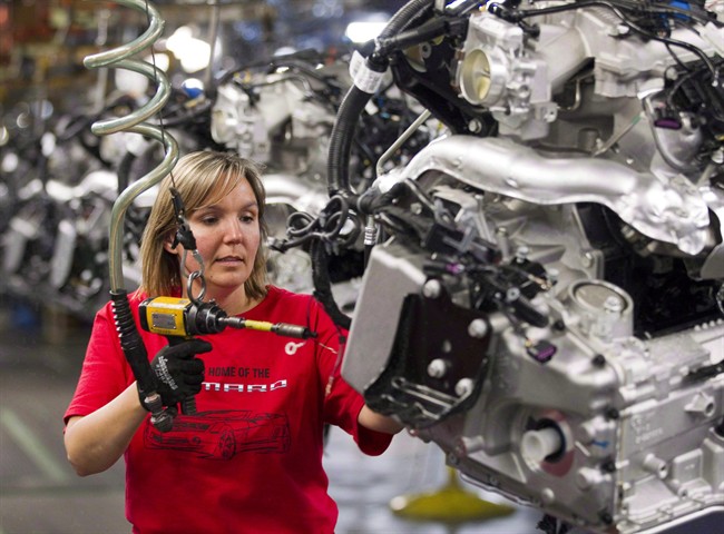 Engine Specialist Jennifer Souch assembles a Camaro engine at the GM factory in Oshawa, Ont., on June 10, 2011.