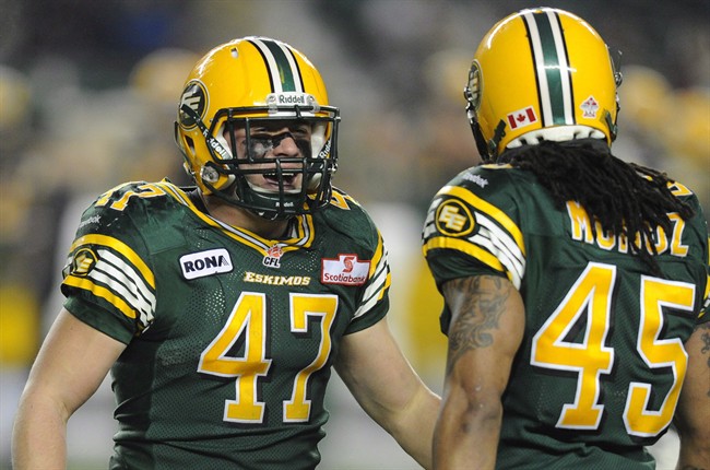 Edmonton Eskimos' JC Sherritt, 47, celebrates getting the CFL record for most tackles in a season against the Calgary Stampeders during CFL football action in Edmonton, Nov. 2, 2012. 