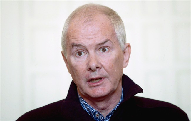 Former Vancouver Olympic organizing committee president and CEO John Furlong reads a statement in Vancouver on September 27, 2012. The man who organized the Vancouver Olympics says he's been cleared by police of sexual-abuse allegations brought by a former student, though the RCMP says the file remains open.