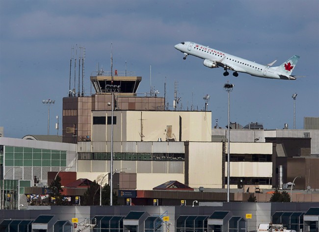 A passenger jet takes off over the terminal at Halifax Stanfield International Airport on Jan. 21, 2013. 