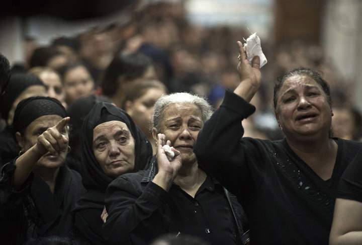 Egyptian Coptic women grieve during the funeral service at the Virgin Mary Coptic Christian church in Cairo's working class neighbourhood of Al-Warrak, on October 21, 2013, of four victims, gunned down as they attended a wedding the previous evening at the same church.