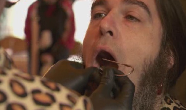 Sweet Pepper Klopek set a world record for lifting the most weight from fish hooks in his face