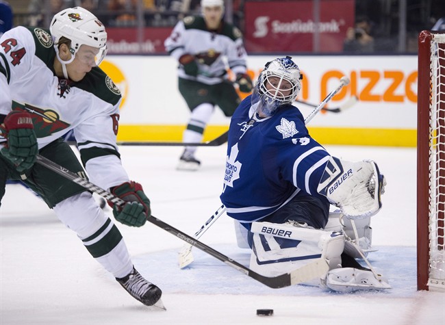 Toronto Maple Leafs goaltender James Reimer makes a save on Minnesota Wild centre Mikael Granlund (64) during third period NHL action in Toronto on Tuesday October 15, 2013. 