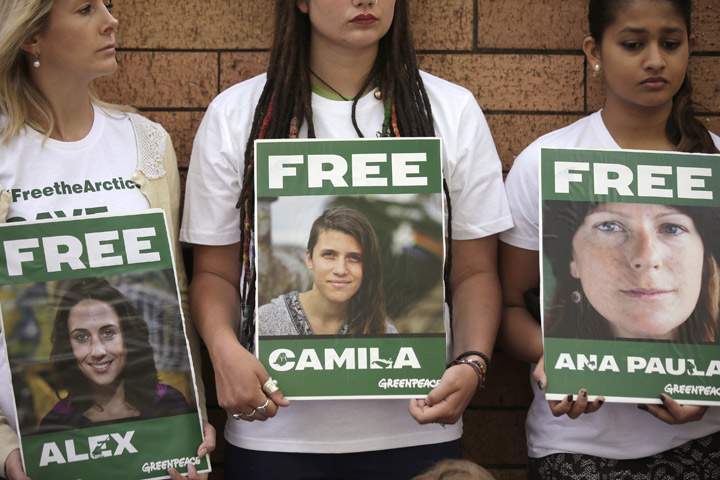 Greenpeace supporters, holding placards with images of detained activists, gather outside the Russian consulate in Sydney, Friday, Oct. 18, 2013, to support a group of activists who were detained by Russia last month for an Arctic protest.