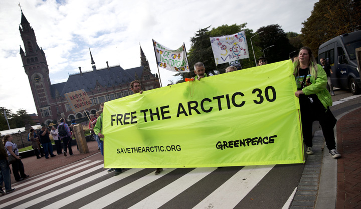 Greenpeace activists and supporters protest during a solidarity march for 30 activists jailed by Russia, from the Russian embassy to the Peace Palace in The Hague on October 5, 2013.  