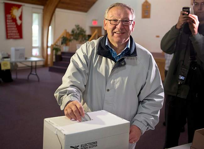 Premier Darrell Dexter votes in the Nova Scotia provincial election in Cole Harbour, N.S., near Halifax on Tuesday, Oct. 8, 2013. THE CANADIAN PRESS/Andrew Vaughan.