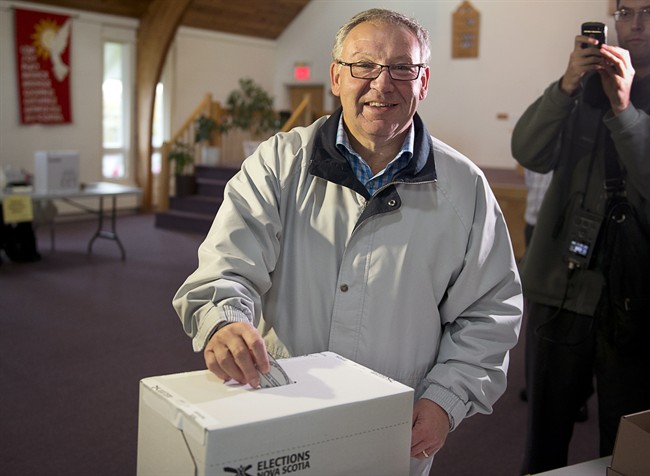 Darrell Dexter votes in the Nova Scotia provincial election in Cole Harbour, N.S. on Oct. 8, 2013.