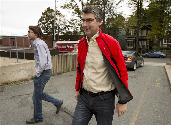 Nova Scotia Liberal Leader Stephen McNeil, accompanied by his son Jeffrey, left, makes a campaign stop in Halifax on Monday, Oct. 7, 2013. The Nova Scotia election is on Tuesday, October 8. 