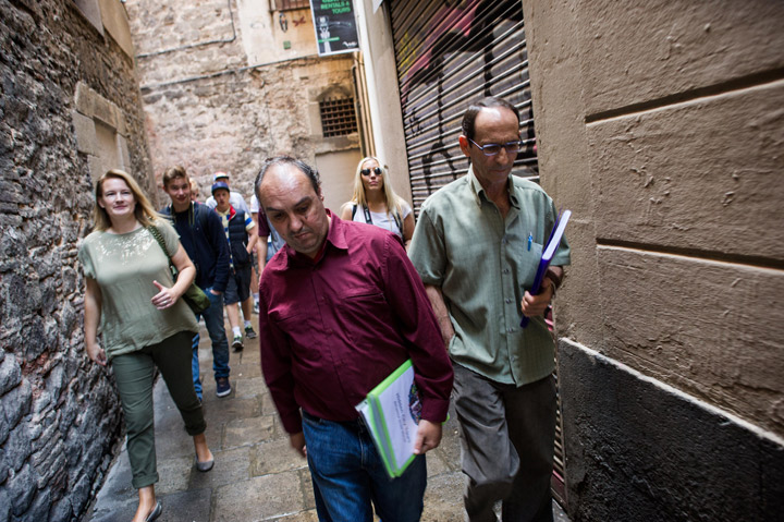Juan Carlos (C), 45, long-term unemployee and homeless Lisa Grace (L), founder of 'Hidden City Tours' lead a group of Danish tourist on October 7, 2013 in Barcelona, Spain. Lisa Grace, a British entrepreneur, has launched 'Hidden City Tours', a service offering visitors an alternative view of Barcelona guided by homeless people.