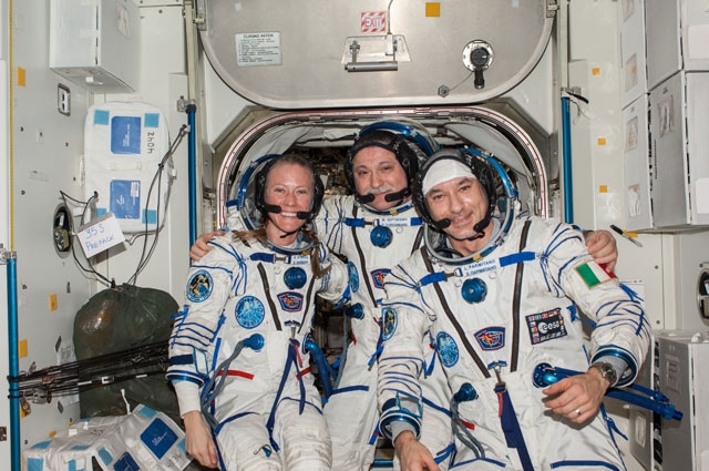Attired in Russian Sokol launch and entry suits, Commander Fyodor Yurchikhin (centre) along with Flight Engineers Karen Nyberg and Luca Parmitano pose for a portrait in the Unity node of the International Space Station.