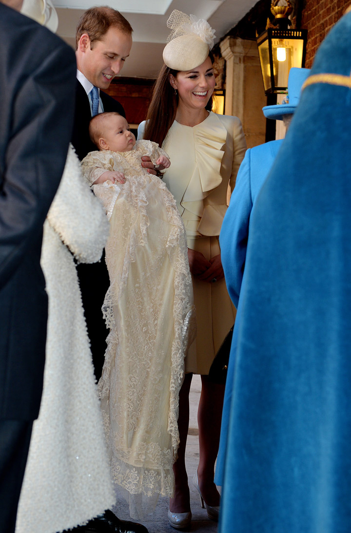 Prince William, Duke of Cambridge and Catherine, Duchess of Cambridge talk to Queen Elizabeth II (R) as they arrive, holding their son Prince George, at Chapel Royal in St James’s Palace, ahead of the christening of the three month-old Prince George of Cambridge by the Archbishop of Canterbury on October 23, 2013 in London, England. (Photo credit: Getty Images)