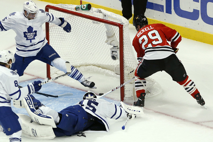 Chicago Blackhawks left wing Bryan Bickell (29) scores a goal past Toronto Maple Leafs goalie Jonathan Bernier (45) and defenseman Paul Ranger, top left, during the second period of an NHL hockey game Saturday, Oct. 19, 2013, in Chicago.