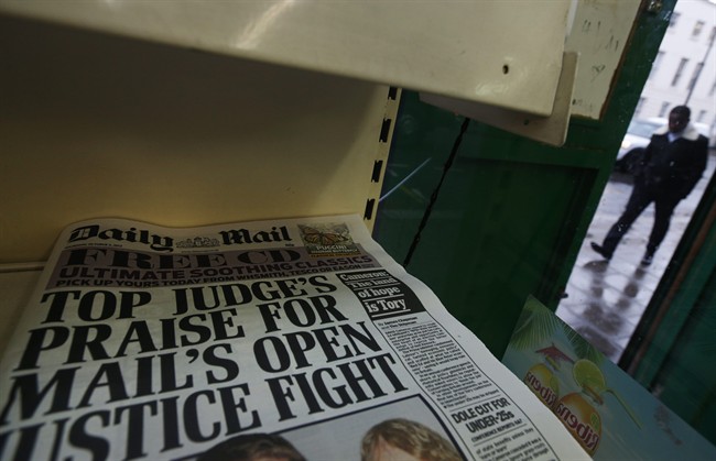 Copies of Britain's Daily Mail newspaper are offered for sale at a newsagent in London, Thursday, Oct. 3, 2013.
