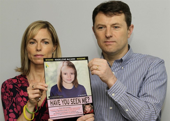 FILE - In this May 2, 2012 file photo, Kate and Gerry McCann pose for the media with a missing poster depicting an age progression computer generated image of their daughter Madeleine at nine years of age, to mark her birthday and the 5th anniversary of her disappearance during a family vacation in southern Portugal in May 2007, during a news conference in London.