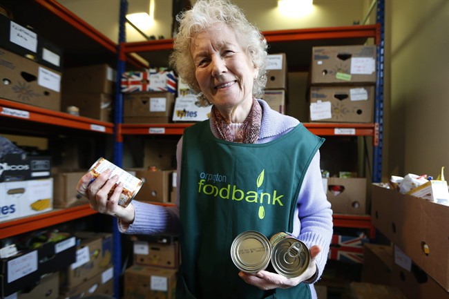 Food bank volunteer Diana Grant sorts cans in this file photo.